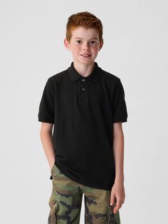 Soft woven knit uniform polo shirt.  Polo collar, buttons at front.  Short sleeves.  Straight, easy fit.  Hits at the hip. Black Polo Shirt With Button Closure, Classic Short Sleeve Polo Shirt For School, Classic Polo Shirt With Polo Collar For School, Classic Polo Shirt For School, Classic School Polo Shirt, Classic Cotton Polo Shirt For School, Classic Solid Polo Shirt For School, School Collared Polo Shirt, Gap Collared Top With Placket