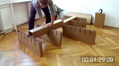 a man is moving cardboard boxes on the floor