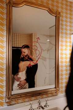 a woman is taking a selfie in front of a bathroom mirror with her reflection