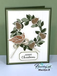 a handmade christmas card with a bird on a tree branch and merry christmas lettering