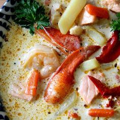 a bowl filled with seafood and vegetables on top of a table