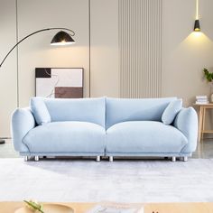 a blue couch sitting in the middle of a living room