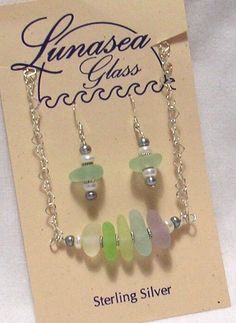 AWESOME FIVE HORIZONTALLY STACKED SEA GLASS NECKLACE WITH MATCHING EARRINGS by LUNASEA TREASURES of New England.  Genuine surf tumbled center drilled sea glass pieces in shades lavendar, yellow, light green, aqua & seafoam white.  Sea glass sizes range from 14mm to 18mm long.  The sea glass is sandwiched by sterling silver daisy rondelles & has two 6mm white &  two 5mm silvery moss green fresh water pearls on each side.  Pendant hangs from a 15" 5mm heart link chain with a lobster clasp.  The ma Seaglass Jewelry, Artisan Jewelry Necklaces, Sea Glass Bracelet, White Sea Glass, Green Aqua, White Sea, Fresh Water Pearls, Handcrafted Artisan Jewelry, Sea Glass Necklace