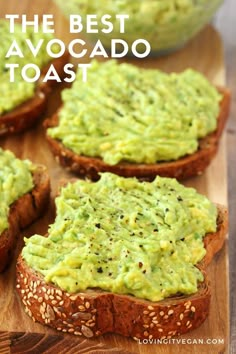 four pieces of bread with guacamole spread on top and sesame seeds in the middle