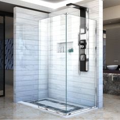 a bathroom with a walk in shower next to a white tiled wall and counter top