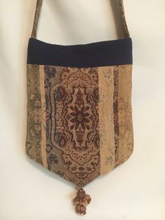 a purse with a tassel hanging from it's side