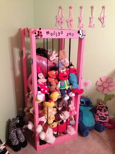 a pink shelf filled with lots of stuffed animals