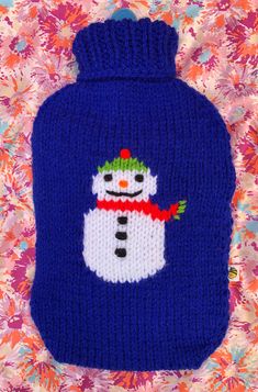 a blue knitted hot water bottle with a snowman on it