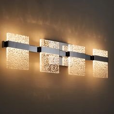 a modern bathroom light fixture with square glass blocks on the side and rectangular lights above it