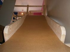 an empty room with carpeted stairs leading up to the second floor and another hallway in the background