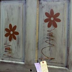 the door is painted brown and has flowers on it, with a price tag hanging in front of them