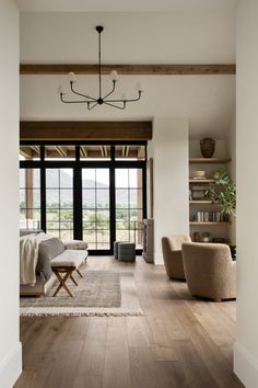 a living room filled with furniture and a large glass door that leads to a patio