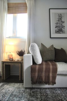 a living room with a couch, table and window