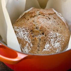 a loaf of bread sitting in a red pot