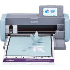 a printer that is sitting on top of a paper cutting mat with the image of a flower cut out