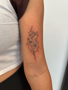 a woman with a tattoo on her arm has a bouquet of flowers in the center