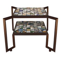 a wooden table topped with lots of different colored glass tiles on top of each other