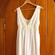 Dreamy 1960s ankle length nightgown w/ plunging neckline & empire waist. The deep V bodice features a whimsical daisy print & is lined w/ matching yellow rick-rack trim. Delicate waist tie extends from empire waist for a more secure & flattering fit. Labeled size S. A quintessential piece of mid-century lounge wear, made by Saks Fifth Avenue. Please reference flat Measurements provided below for fit.  Measurements: Pit to Pit- 17.5"  Empire Waist- 15.75" (w/ back tie for adjustment) Full Length- 52" (40" skirt length, 12" bust length from top of shoulder to center empire waist) Bust Cup- 7.5" wide & 12" long each Condition: In excellent vintage condition. No flaws to note. *All items are vintage & may show natural signs of wear. Any significant flaws will be noted. Price includes the secur Night Gown Vintage, Lounge Wear Dress, Floral Lounge, Gown Vintage, Vintage Nightgown, Women's Nightgowns, Rick Rack, White Daisy, Daisy Print