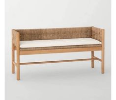 a wooden bench with a white cushion on it