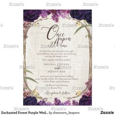 an ornate frame with purple flowers and greenery in the center, on top of a linen