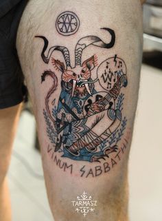 a tattoo on the leg of a man with an image of a demon and devil