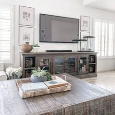 a large flat screen tv mounted to the side of a wall in a living room