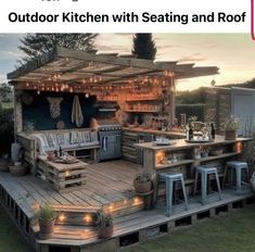 an outdoor kitchen made out of pallets with lights on the roof and stools