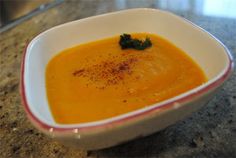 a white bowl filled with soup on top of a counter