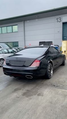 a black car parked in front of a building