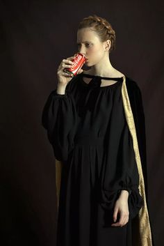 a woman in a black dress holding a candy bar