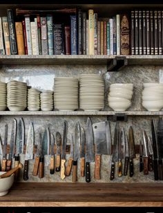 the shelves are filled with many different types of kitchen utensils