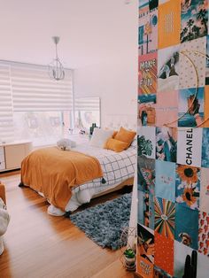 a bed room with a neatly made bed and lots of pictures on the wall