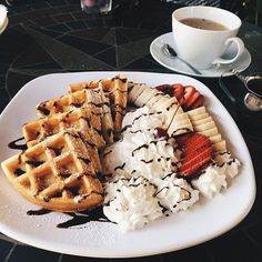 waffles, ice cream and strawberries on a white plate