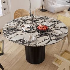 a marble table with plates and fruit on it