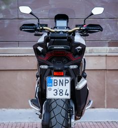 the back end of a motorcycle parked in front of a building