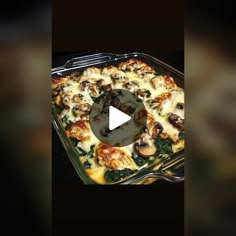 a casserole dish with mushrooms and spinach in it on a black background