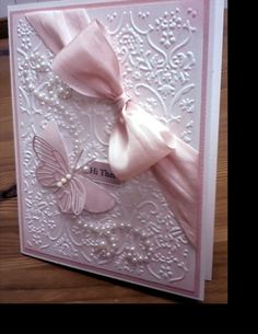 a card with a pink bow on it