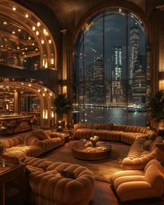 a living room filled with lots of furniture and large windows overlooking the city at night