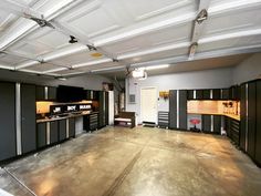 an empty garage with lots of cabinets in it