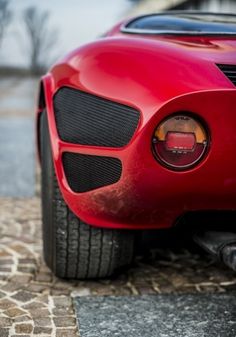 the front end of a red sports car