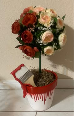 a potted plant with flowers and paint dripping on it