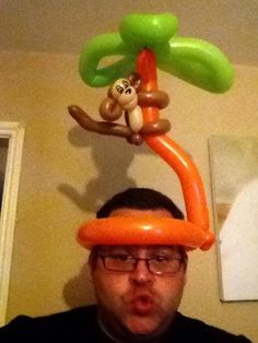 a man with an inflatable monkey on his head