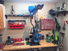 a workbench with many tools on it and some shelves in the back ground