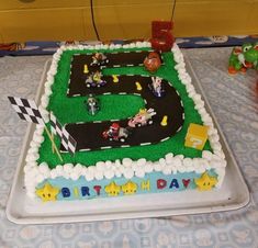 a birthday cake that is shaped like a race track