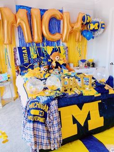 a bed room with balloons and decorations on the walls, including letters that spell out michigan