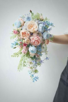 Cascading bridal bouquet in pink, peach, and blue Pink Peonies And Blue Hydrangeas, Pastel Colorful Bouquet, Pastels Wedding Bouquet, Bridgerton Flower Bouquet, Vintage Spring Wedding Dress, Xv Flower Centerpieces, Bridgerton Pastel Wedding Theme, Low Spring Centerpieces, Wedding Flowers With Blue Dresses