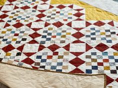 a red, white and blue quilt is laying on the floor