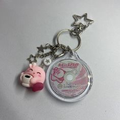 a keychain with a pig and star charms on it's front side