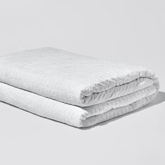 two white blankets folded on top of each other