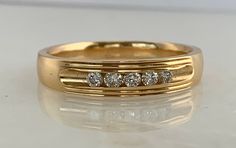 Here is a man's 14k yellow gold diamond band. This beautiful ring is set with 5 round brilliant diamonds that are nice, bright white stones. Wear this ring as a wedding band or as an accessory to your outfit! Materials: 14k Yellow Gold Stone: 5-RB .15cttw, 5mm Size: 10.75 Weight: 5.3 grams Sku: 20SB111118ACI If you have any questions on this item, please message us! GandDJewelers.etsy.com For ring sizing, please contact us for information. Please note that all of our pieces have been analyzed &a 3grams Gold Rings, Gold Diamond Band, White Stones, Bezel Set Diamond, Gold Stone, Beautiful Ring, Diamond Band, Brilliant Diamond, Diamond Bands